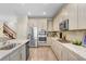 Modern kitchen design with stainless steel appliances, granite countertops, and ample cabinet space at 10703 Morning Dew Way, Tampa, FL 33647