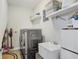 Well-organized laundry room featuring stacked washer/dryer and ample storage space at 10703 Morning Dew Way, Tampa, FL 33647