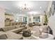 Bright, open-concept living area with modern decor, hardwood floors, and ample seating at 10703 Morning Dew Way, Tampa, FL 33647