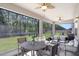 Relaxing screened-in patio with a dining area and comfortable seating at 10703 Morning Dew Way, Tampa, FL 33647