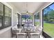 Relaxing covered patio area with comfortable seating and ceiling fans, perfect for outdoor entertaining and enjoying the backyard view at 10703 Morning Dew Way, Tampa, FL 33647