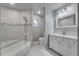 A modern bathroom featuring a tiled shower and updated vanity at 11480 Genter Dr, Spring Hill, FL 34609