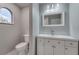 Contemporary bathroom featuring a clean white vanity and fixtures, arched window at 11480 Genter Dr, Spring Hill, FL 34609