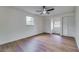 Neutral bedroom with wood floors, ceiling fan, and closet space at 11480 Genter Dr, Spring Hill, FL 34609