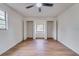 Neutral bedroom with wood floors, ceiling fan, and closet space at 11480 Genter Dr, Spring Hill, FL 34609
