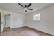A bright bedroom featuring a modern ceiling fan and wood-look floors at 11480 Genter Dr, Spring Hill, FL 34609