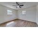A bright, spacious bedroom with wood-look floors and large windows at 11480 Genter Dr, Spring Hill, FL 34609