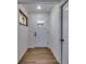 Bright entryway featuring wood floors and a decorative stained-glass window, leading into the home at 11480 Genter Dr, Spring Hill, FL 34609