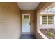 Inviting front door with brick columns and a tiled floor, enhanced by a large window for natural light at 11480 Genter Dr, Spring Hill, FL 34609