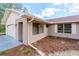 Welcoming front entrance with tidy landscaping and brick-accented design elements at 11480 Genter Dr, Spring Hill, FL 34609