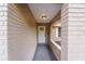 Covered front entrance with brick columns, tiled floor, and a view of the front door at 11480 Genter Dr, Spring Hill, FL 34609