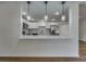 Modern kitchen with white cabinets, stainless steel appliances, and a breakfast bar with pendant lighting at 11480 Genter Dr, Spring Hill, FL 34609
