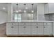 Modern kitchen island with white cabinets, quartz countertop, and stylish pendant lighting at 11480 Genter Dr, Spring Hill, FL 34609
