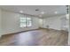 Spacious living area with wood flooring, and natural light, offering seamless flow and versatile layout options at 11480 Genter Dr, Spring Hill, FL 34609
