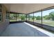 Enclosed patio offers a peaceful outdoor space with views of lush greenery and open sky at 11480 Genter Dr, Spring Hill, FL 34609