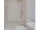 Modern bathroom with walk-in shower, pebble floor and sleek vanity at 11480 Genter Dr, Spring Hill, FL 34609