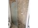 Bathroom featuring a glass shower door and neutral tile walls, along with modern fixtures at 12619 98Th St, Largo, FL 33773