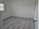 Bright bedroom with wood-look floors, a closet, and a window at 12619 98Th St, Largo, FL 33773