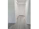 Hallway with wood-look floors and closet space at 12619 98Th St, Largo, FL 33773
