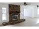 Spacious living room features a stone fireplace and abundant natural light at 12619 98Th St, Largo, FL 33773
