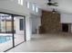 Spacious living room with stone fireplace, tile flooring, and views of the pool area at 12619 98Th St, Largo, FL 33773