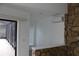 Open living area with stone accent wall, tiled floors, and access to a screened patio at 12619 98Th St, Largo, FL 33773