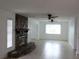 Bright and open living room with a stunning stone fireplace and tile floors at 12619 98Th St, Largo, FL 33773