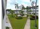 An open courtyard area with vibrant green grass, landscaping, and walkways, inviting residents to relax and enjoy the outdoors at 1325 58Th N St # 204A, St Petersburg, FL 33710
