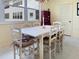 Bright dining room with large windows, white table and chairs, and tiled floor at 1325 58Th N St # 204A, St Petersburg, FL 33710