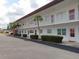 Two story condominium featuring white exterior, trimmed hedges, and a well maintained parking area at 1325 58Th N St # 204A, St Petersburg, FL 33710