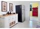 Bright kitchen space with stainless steel refrigerator, white cabinets, and tile floors at 1325 58Th N St # 204A, St Petersburg, FL 33710