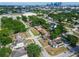 Overhead view of a neighborhood with lush foliage, tidy streets, and city skyscrapers in the distance at 1724 W Saint Conrad St, Tampa, FL 33607