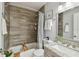 Bathroom with updated tiling in the shower and a granite countertop sink at 1724 W Saint Conrad St, Tampa, FL 33607