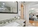 Bathroom vanity with a granite countertop and a view into a bedroom at 1724 W Saint Conrad St, Tampa, FL 33607