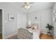 A well-lit bedroom with neutral walls, white closets, and a tufted bed at 1724 W Saint Conrad St, Tampa, FL 33607
