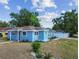 Charming blue single-story home with a well-manicured front yard and a white fence at 1724 W Saint Conrad St, Tampa, FL 33607