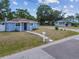 Attractive home exterior featuring a well-kept lawn, tidy landscaping, and a neatly maintained facade at 1724 W Saint Conrad St, Tampa, FL 33607