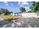 Inviting home exterior with a well-manicured lawn, white picket fence, and a freshly painted facade at 1724 W Saint Conrad St, Tampa, FL 33607