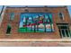 Exterior shot of a brick building featuring a vibrant 'City of Tampa' mural and storefront access at 1724 W Saint Conrad St, Tampa, FL 33607