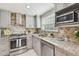 Modern kitchen featuring granite countertops, stainless steel appliances, and tile backsplash at 1724 W Saint Conrad St, Tampa, FL 33607