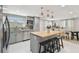 Updated kitchen features gray cabinetry, stainless appliances, and a butcher block island with seating at 1724 W Saint Conrad St, Tampa, FL 33607