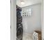 Efficient laundry area featuring a stacked washer and dryer unit with a tile floor at 1724 W Saint Conrad St, Tampa, FL 33607