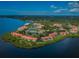 Beautiful aerial view of waterfront condos with community pool, tennis courts and lush landscaping at 1805 Mariner Dr # 52, Tarpon Springs, FL 34689