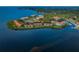 Panoramic aerial view of waterfront community with tennis courts, boat docks and red tile roofs at 1805 Mariner Dr # 52, Tarpon Springs, FL 34689