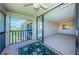 Cozy balcony with tile flooring offering serene views of the lush landscaping and building at 1805 Mariner Dr # 52, Tarpon Springs, FL 34689