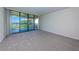 Bright bedroom features a sliding glass door leading to a balcony with scenic outdoor views at 1805 Mariner Dr # 52, Tarpon Springs, FL 34689