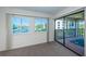 Carpeted bedroom with windows and sliding glass door to screened-in porch with water views at 1805 Mariner Dr # 52, Tarpon Springs, FL 34689