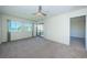 Bright bedroom with a ceiling fan, windows, and sliding glass doors leading to the outdoor view at 1805 Mariner Dr # 52, Tarpon Springs, FL 34689