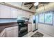 A functional kitchen featuring light wood cabinets, black appliances, and tile flooring at 1805 Mariner Dr # 52, Tarpon Springs, FL 34689