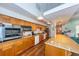Spacious kitchen featuring stainless steel appliances, wood cabinets, granite countertops and hardwood floors at 1805 Mariner Dr # 52, Tarpon Springs, FL 34689
